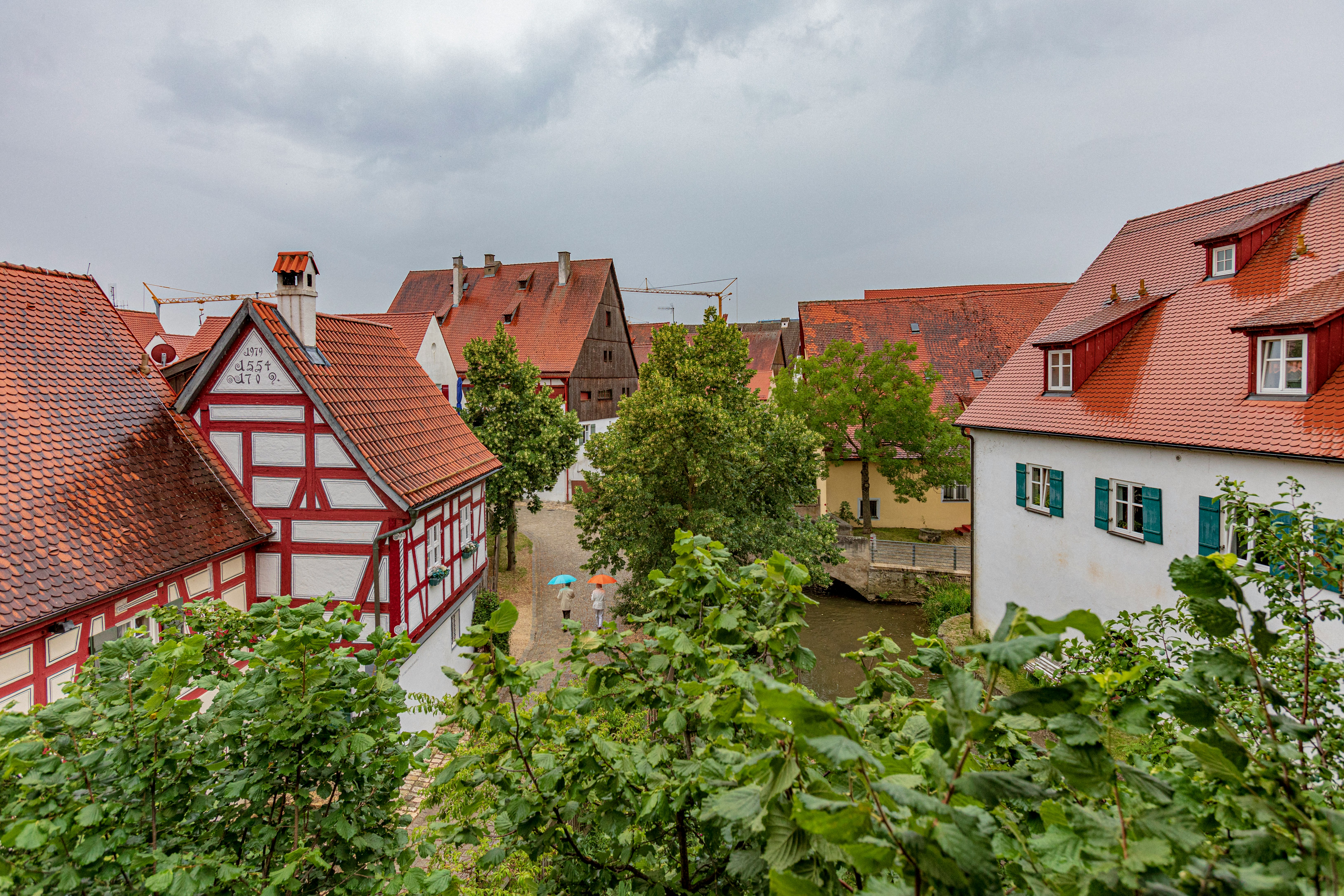 white and brown houses under cloudy sky
